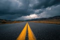Empty Highway into the Mountains Under a Dramatic Stormy Sky Royalty Free Stock Photo