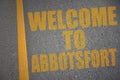 asphalt road with text welcome to Abbotsford near yellow line