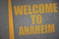 asphalt road with text welcome to Anaheim near yellow line Royalty Free Stock Photo