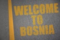 asphalt road with text welcome to bosnia near yellow line.