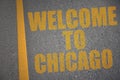 asphalt road with text welcome to chicago near yellow line Royalty Free Stock Photo