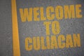 asphalt road with text welcome to Culiacan near yellow line Royalty Free Stock Photo