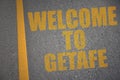 asphalt road with text welcome to Getafe near yellow line Royalty Free Stock Photo