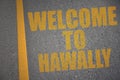 asphalt road with text welcome to Hawally near yellow line