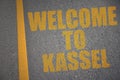 asphalt road with text welcome to Kassel near yellow line Royalty Free Stock Photo