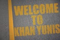 asphalt road with text welcome to Khan Yunis near yellow line Royalty Free Stock Photo