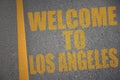 asphalt road with text welcome to los angeles near yellow line Royalty Free Stock Photo