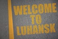 asphalt road with text welcome to Luhansk near yellow line Royalty Free Stock Photo