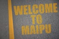 asphalt road with text welcome to Maipu near yellow line