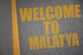 asphalt road with text welcome to Malatya near yellow line