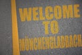 asphalt road with text welcome to Monchengladbach near yellow line Royalty Free Stock Photo