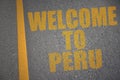 asphalt road with text welcome to peru near yellow line.