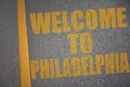 asphalt road with text welcome to Philadelphia near yellow line Royalty Free Stock Photo