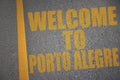 asphalt road with text welcome to Porto Alegre near yellow line