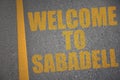 asphalt road with text welcome to Sabadell near yellow line Royalty Free Stock Photo