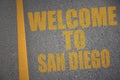 asphalt road with text welcome to San Diego near yellow line Royalty Free Stock Photo