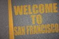 asphalt road with text welcome to San Francisco near yellow line Royalty Free Stock Photo