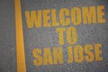 asphalt road with text welcome to san jose near yellow line Royalty Free Stock Photo