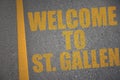 asphalt road with text welcome to St. Gallen near yellow line