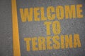 asphalt road with text welcome to Teresina near yellow line