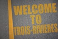 asphalt road with text welcome to Trois-Rivieres near yellow line