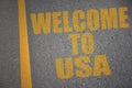 asphalt road with text welcome to usa near yellow line. Royalty Free Stock Photo