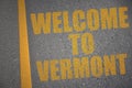 asphalt road with text welcome to vermont near yellow line. Royalty Free Stock Photo
