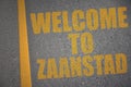 asphalt road with text welcome to Zaanstad near yellow line Royalty Free Stock Photo