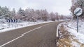 Asphalt road to the snowy mountain with traffic signs allowed overtaking Royalty Free Stock Photo