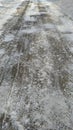 Asphalt road, track partially cleared of snow Royalty Free Stock Photo