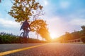 Asphalt road on which a cyclist rides. Autumn bike ride Royalty Free Stock Photo