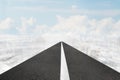 Asphalt road of white line in sky with clouds cityscapes