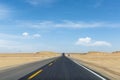 Asphalt road through the wind erosion physiognomy Royalty Free Stock Photo