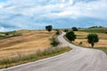 Asphalt road winding through hills