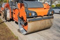 Asphalt roller side view. Road repair work, paving asphalt. Road roller working on the new road construction site Royalty Free Stock Photo