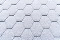 Asphalt roofing shingles texture covered with light snow. House roof shingles covered with frost. Snow covered roof of the house Royalty Free Stock Photo