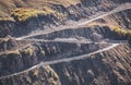 Asphalt serpentine track in the mountains with two turns rises from the valley up