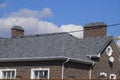 Asphalt shingle. Decorative bitumen shingles on the roof of a brick house. Royalty Free Stock Photo