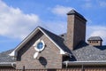 Asphalt shingle. Decorative bitumen shingles on the roof of a brick house. Royalty Free Stock Photo
