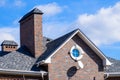 Asphalt . Decorative bitumen shingles on the roof of a brick house Royalty Free Stock Photo