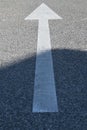 Asphalt sign: white arrow on the concrete texture Royalty Free Stock Photo