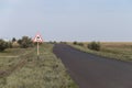 Asphalt steppe road. Road sign \