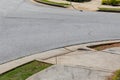 Asphalt street bordered by formed curbs, sidewalks, and grass, handicap ramp access Royalty Free Stock Photo