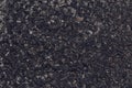 Asphalt texture, natural black pattern of roadway for design, grainy surface of pavement. Abstract dark wallpaper. Old weathered
