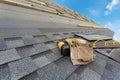 Asphalt tile roof and tool belt lying on new house under construction Royalty Free Stock Photo