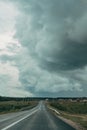 Asphalt track road with a stormy dark sky background. Royalty Free Stock Photo