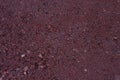 Asphalt wet red road surface with little stones texture macro Royalty Free Stock Photo