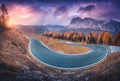 Asphalt winding road in mountains at colorful sunset in autumn