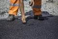 Asphalt worker patching by hands