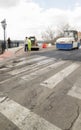 Asphalt works on the city road with machinery and workers.